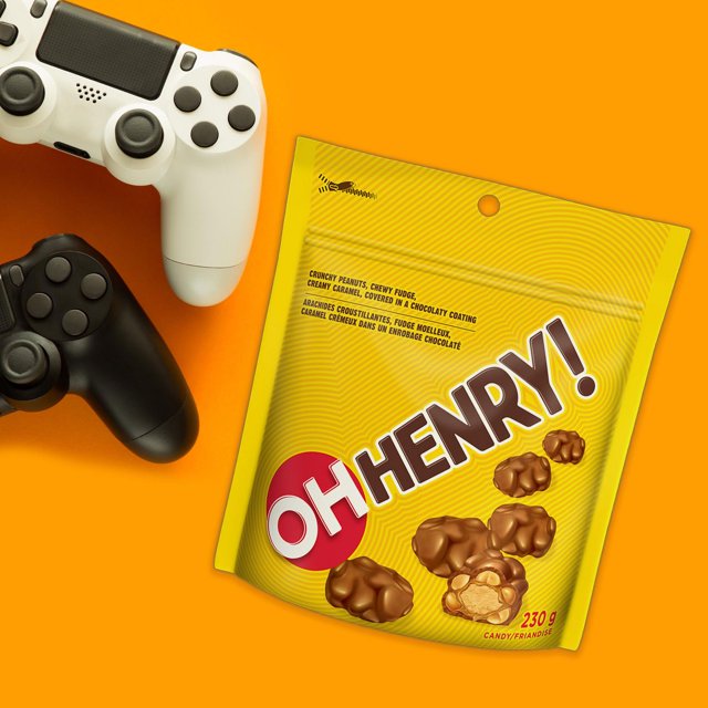 OH HENRY! 230g Chocolatey Candy Bites package displayed with gaming controllers