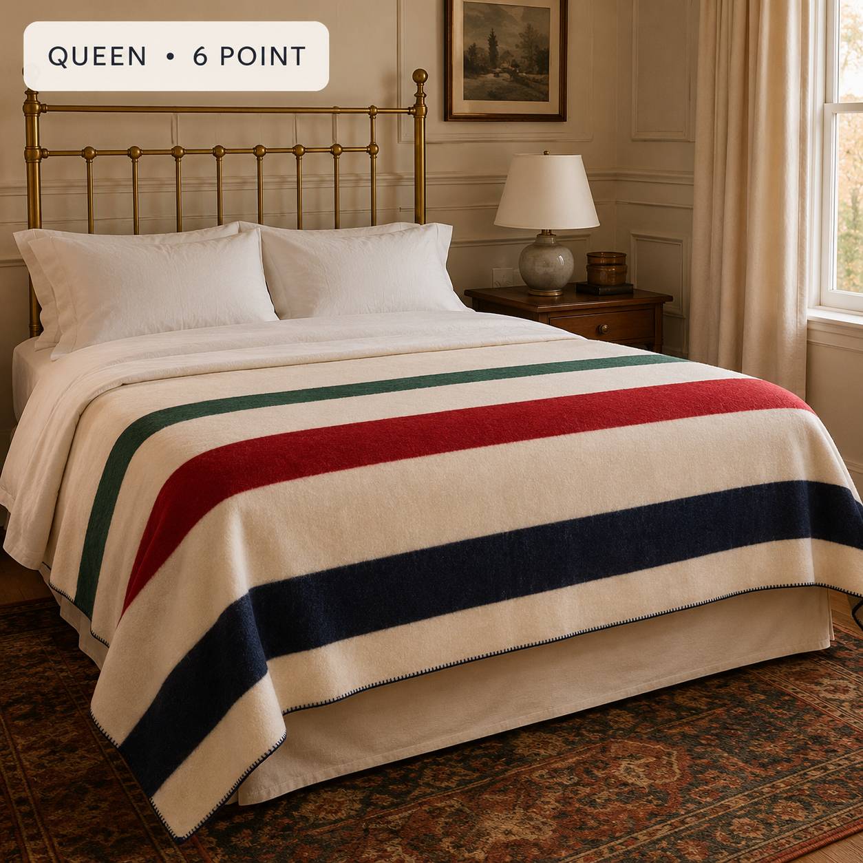 Folded Hudson's Bay Company 6 Point wool blanket with natural fabric and colorful multi stripes displayed on a wooden table.