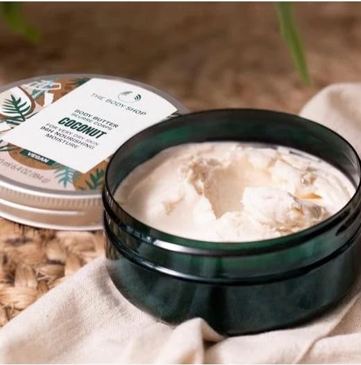 The Body Shop Coconut Body Butter shown with its rich creamy texture in an open container
