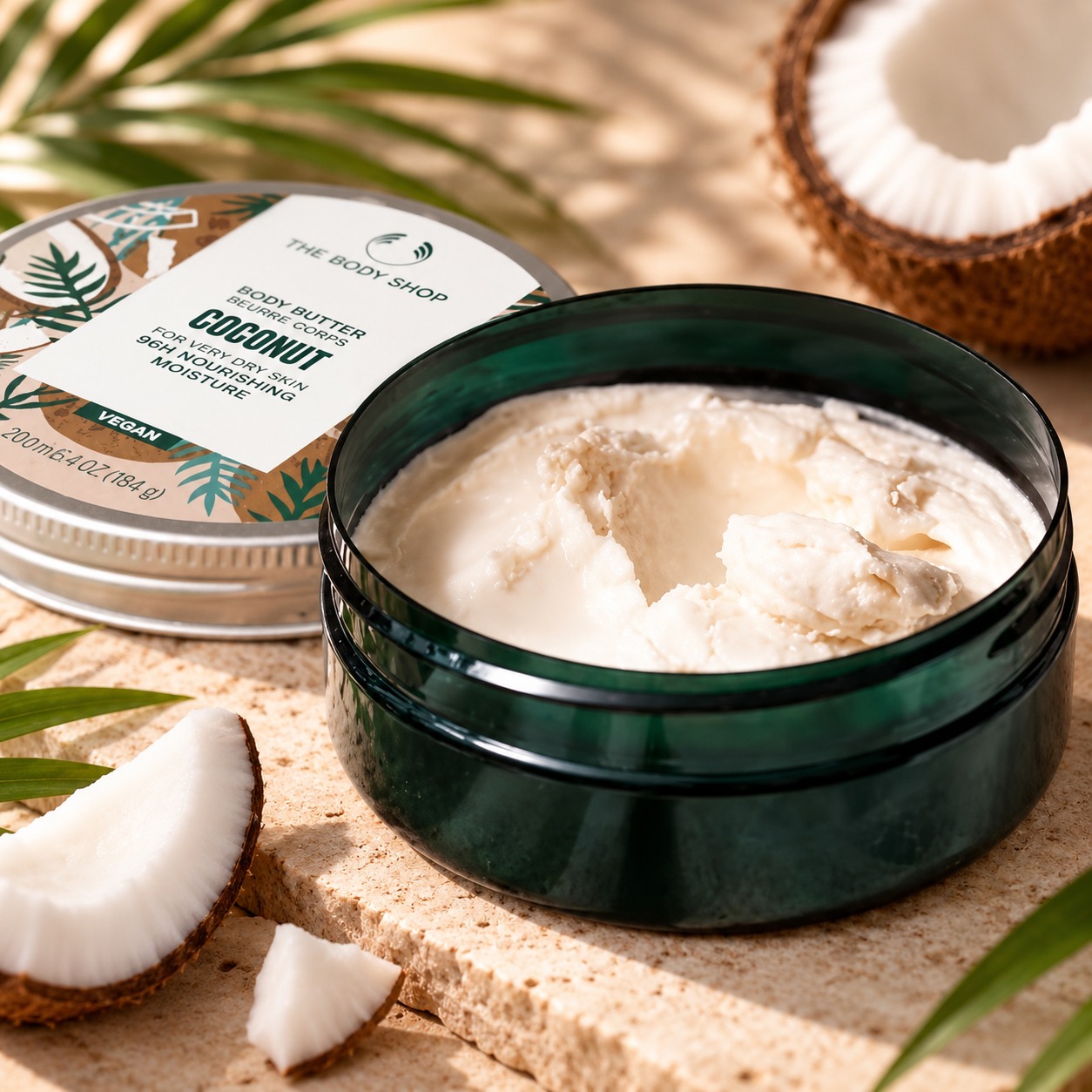 The Body Shop Coconut Body Butter shown with its rich creamy texture in an open container